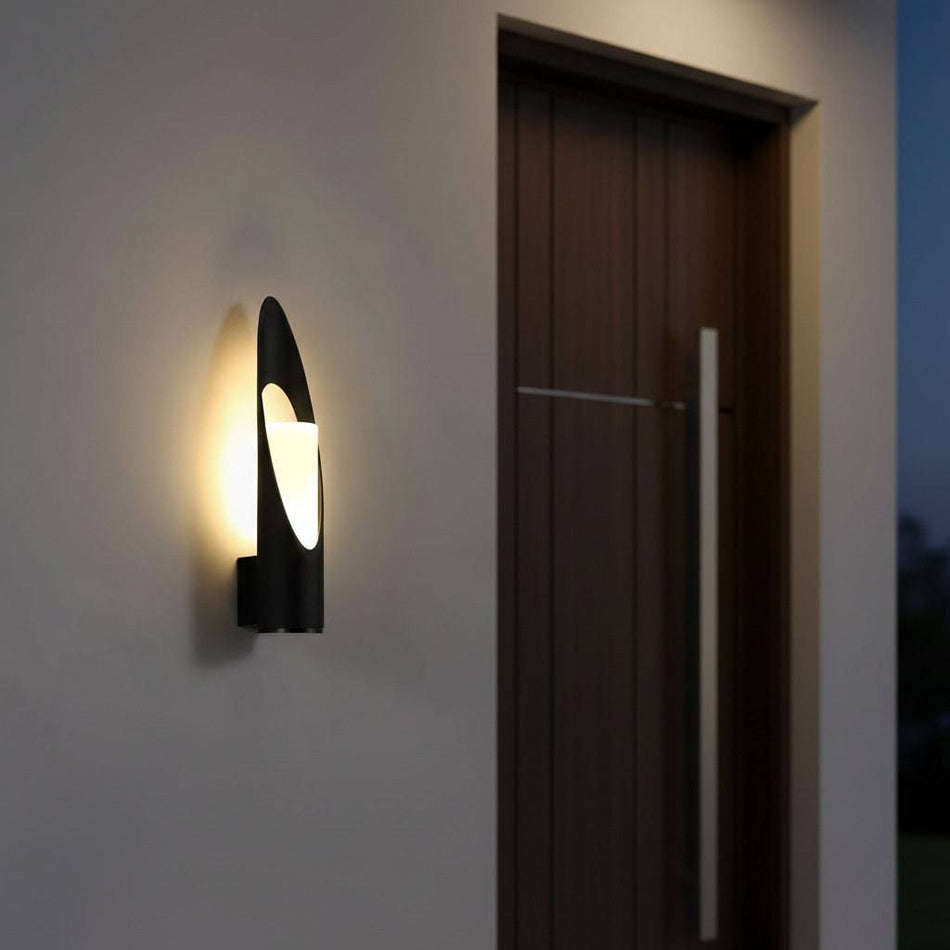black outdoor LED wall lantern mounted on the wall of a modern home next to the front door 