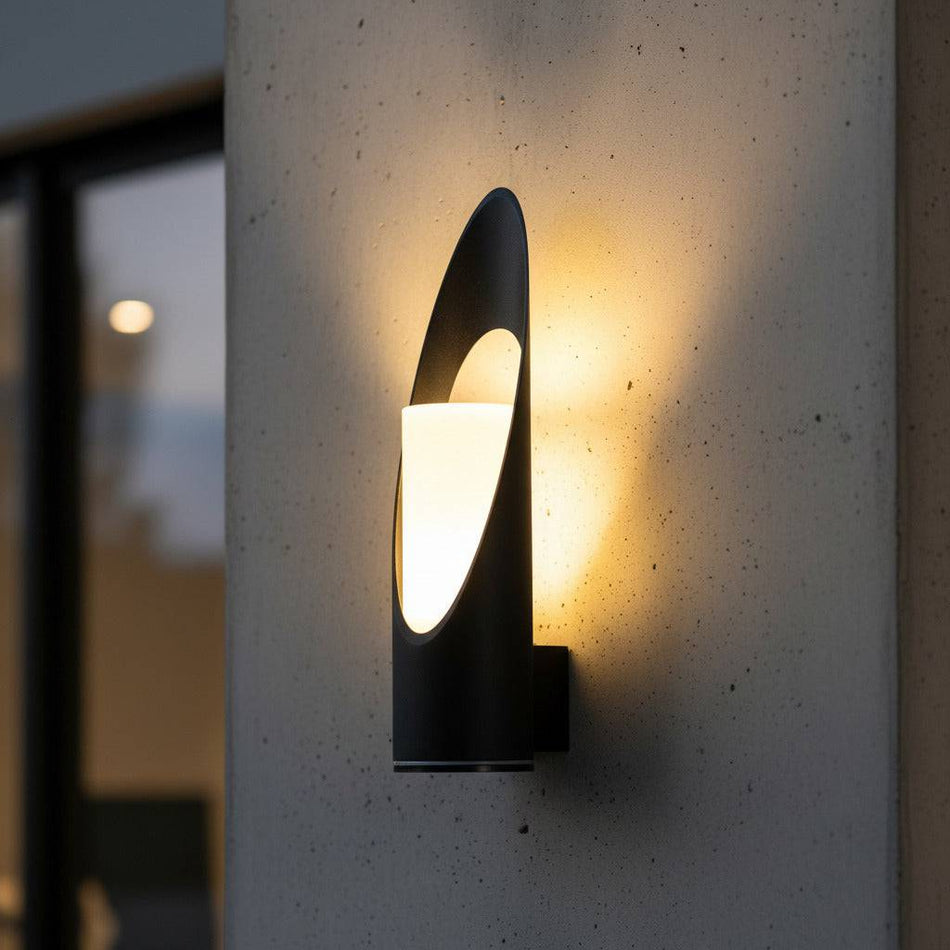 black external wall lantern mounted on a concrete wall outside a modern house 