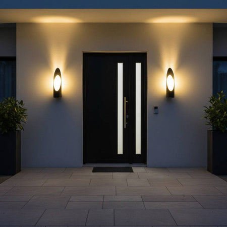 black external wall lantern mounted either side of the entrance door of a modern home 