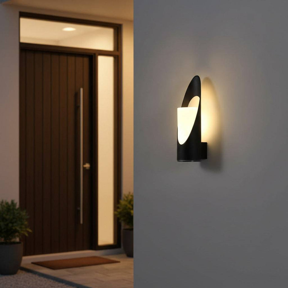 black outdoor wall light mounted on white exterior wall with a wooden front door in the background