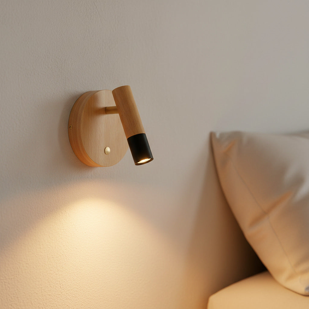 black adjustable wooden reading lamp mounted on the wall next to a bed