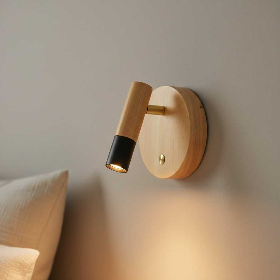 black adjustable wooden reading lamp mounted on the wall next to a bed 