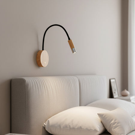 chrome flexible wooden reading light mounted over a bed 