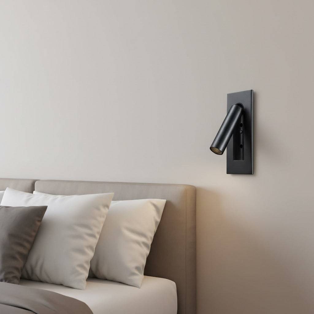 black recessed LED reading wall light mounted on the wall in a modern bedroom next to the bed 