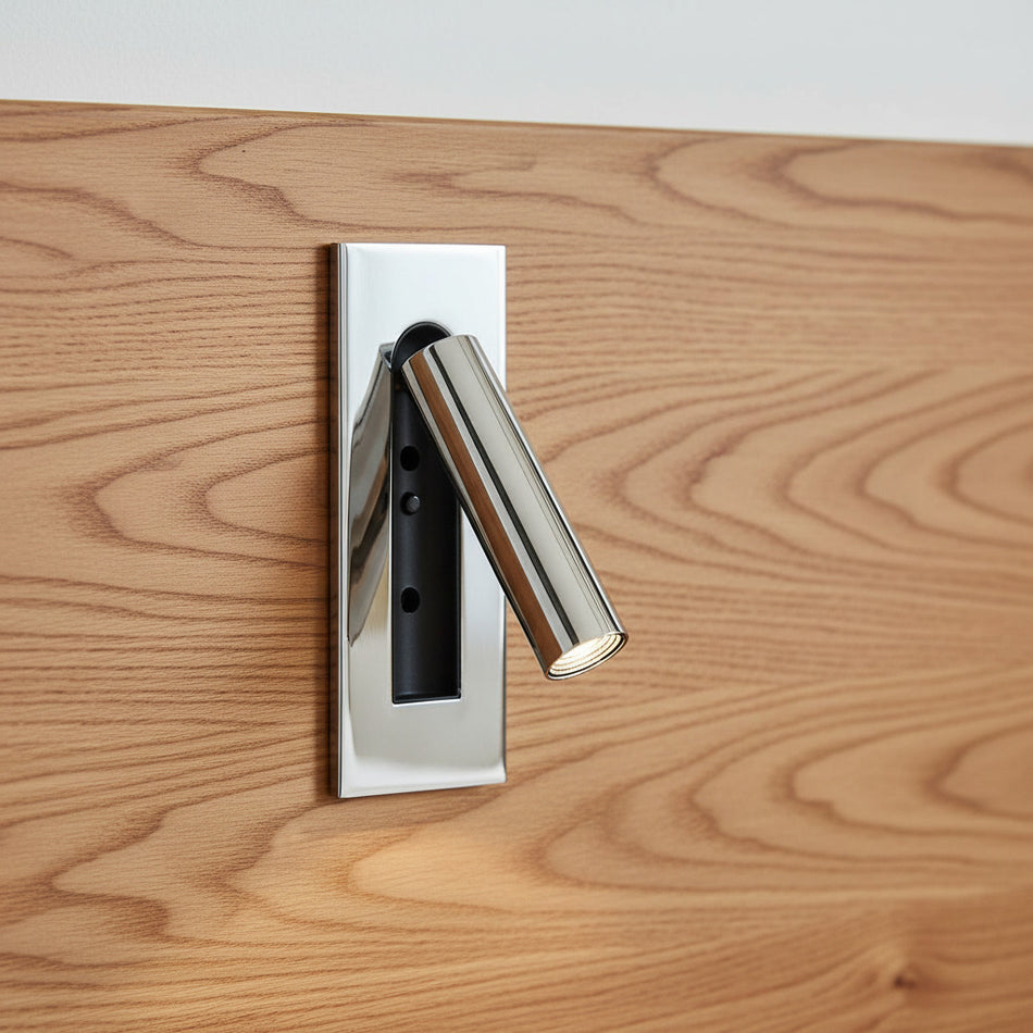 chrome recessed adjustable LED reading wall lamp mounted on a wooden bed headboard