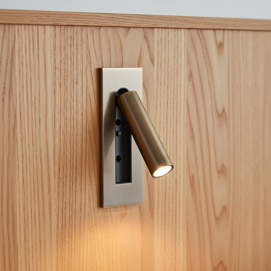 brushed copper recessed adjustable bedroom reading light mounted on a wooden headboard