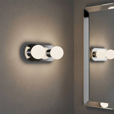 LED vanity wall light mounted next to a bathroom mirror 