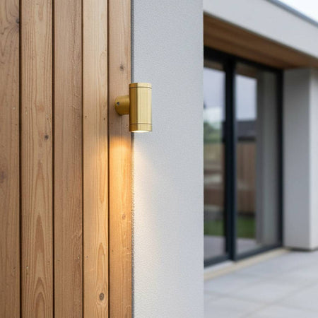 exterior brass wall light mounted on a wooden wall of a modern home outside 
