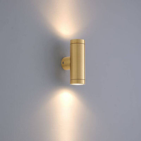 brass up down outdoor wall light mounted on a white wall 
