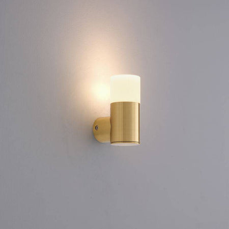 brass outdoor wall light mounted on a white wall 