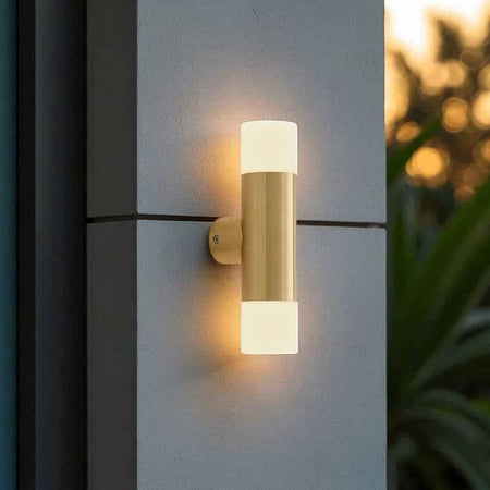 brass up and down exterior light mounted on the concrete wall of a modern house
