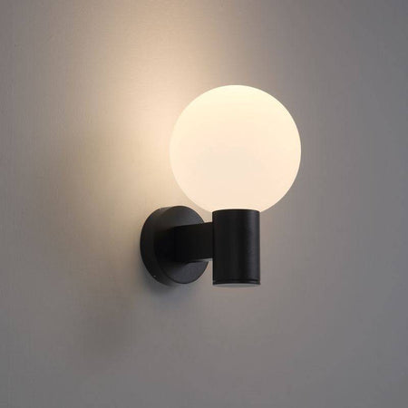 black globe outdoor wall light mounted on a white wall 
