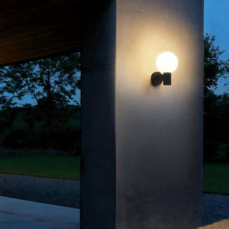 black blog outdoor wall light mounted on a grey exterior wall 