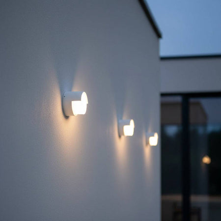 white garden wall light mounted in a row on a white wall of a modern house
