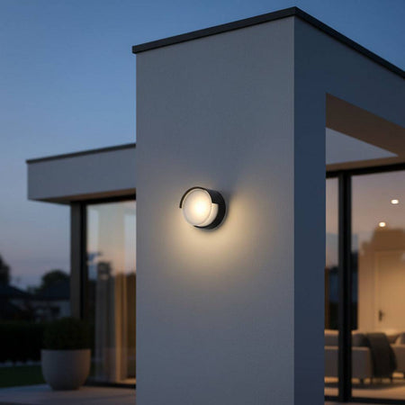 black LED exterior wall light fitted on the white wall of a modern home exterior