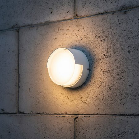 white modern outside wall light mounted on a brick outdoor wall 