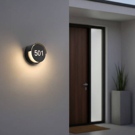 black illuminated door number mounted on the wall outside of a house
