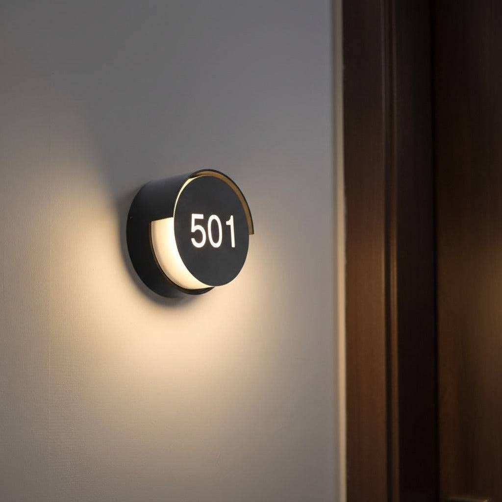 LED hotel room number sign mounted on the wall next to a hotel door