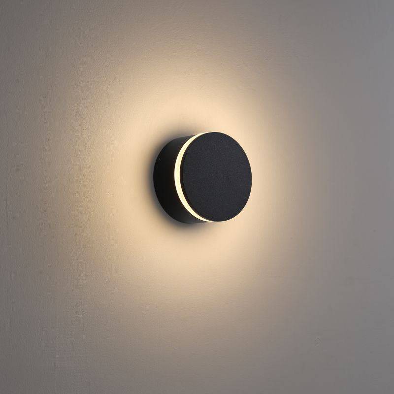 black wall outdoor lamp mounted on a white wall and illuminated