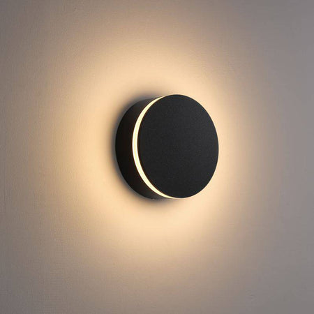 black LED outdoor wall lamp shown mounted on a white wall 