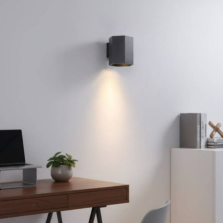 Black interior LED wall downlight on a white wall in a modern home