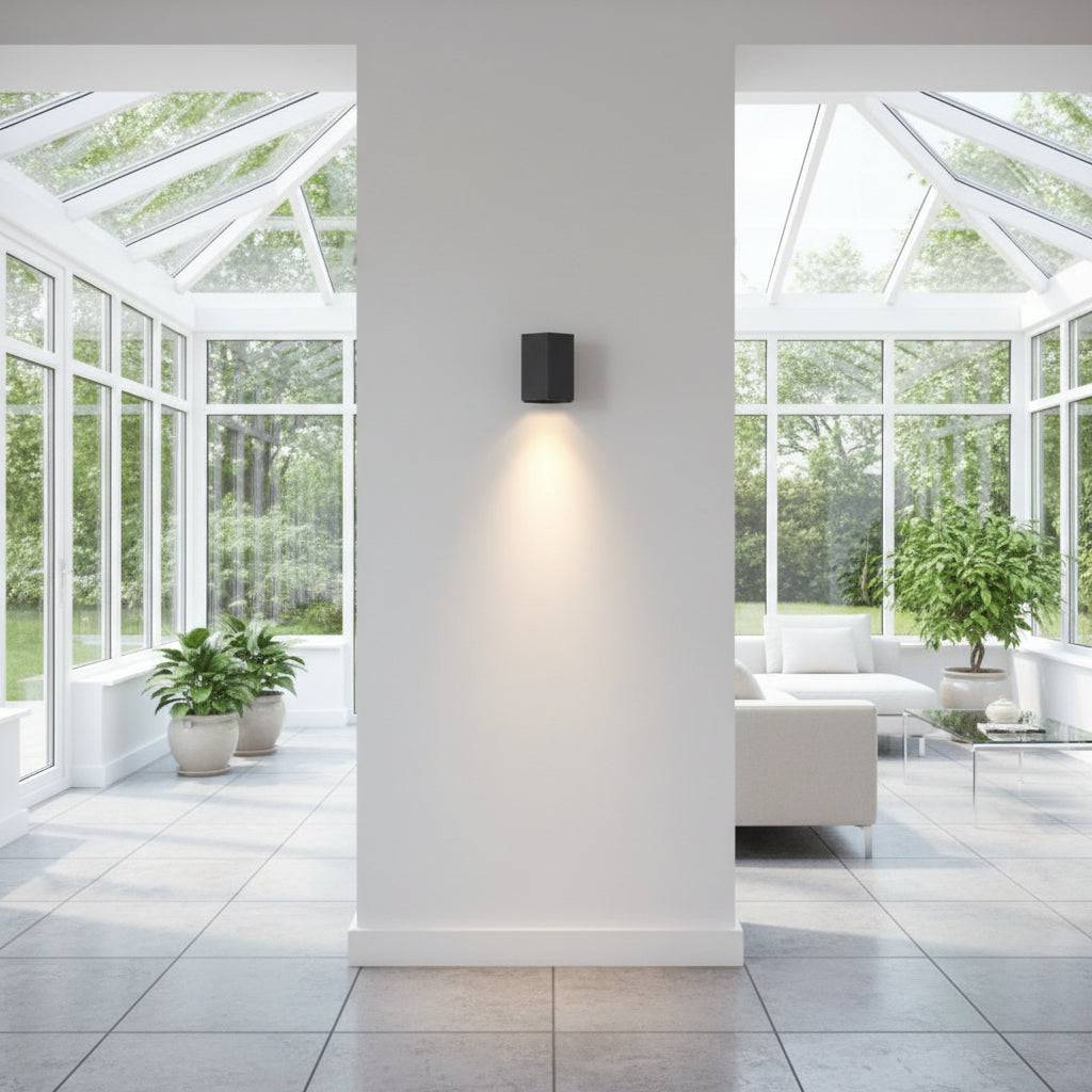 Black interior LED wall downlight in a modern conservatory looking towards the garden