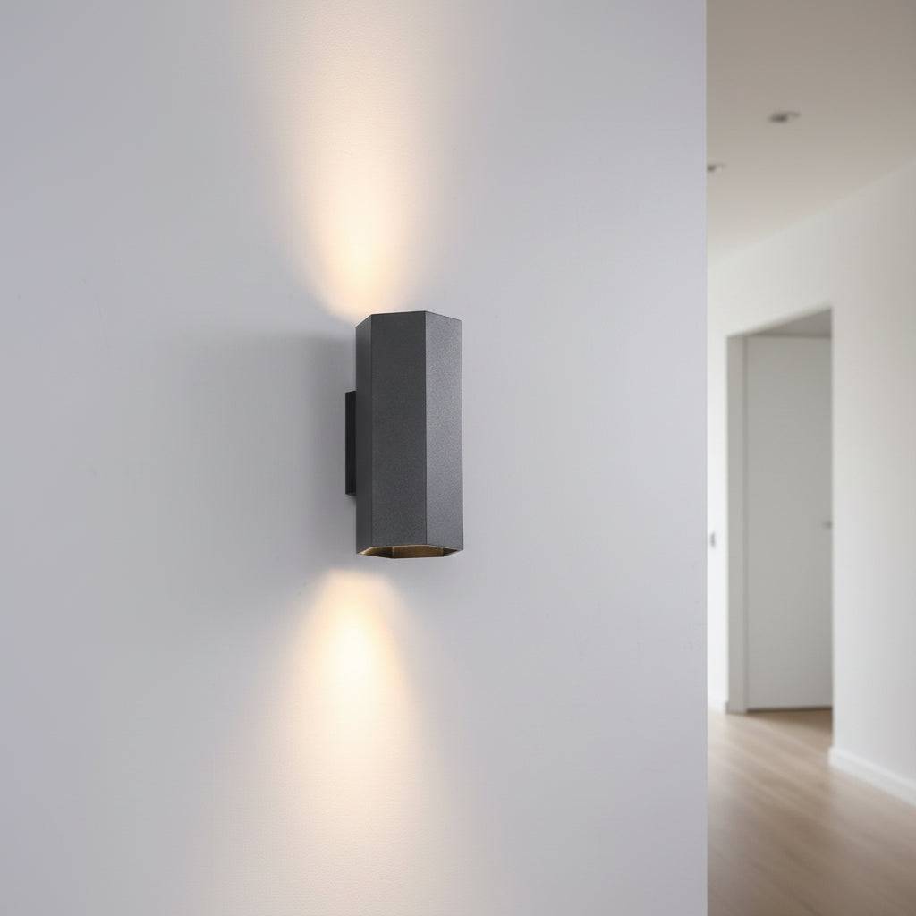 Black up and down indoor wall light  in a modern hallway