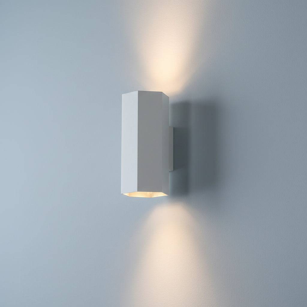 White interior up and down wall light on  a pale blue coloured wall