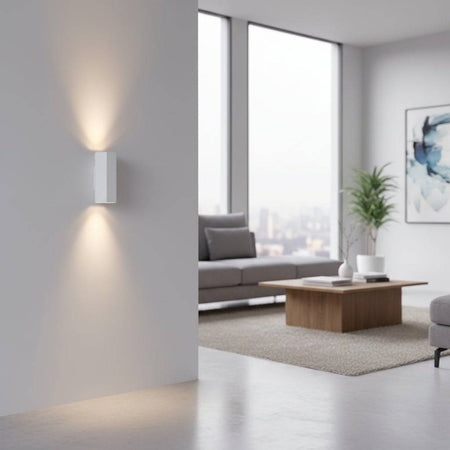 White interior up and down wall light on  a grey wall in a lounge area