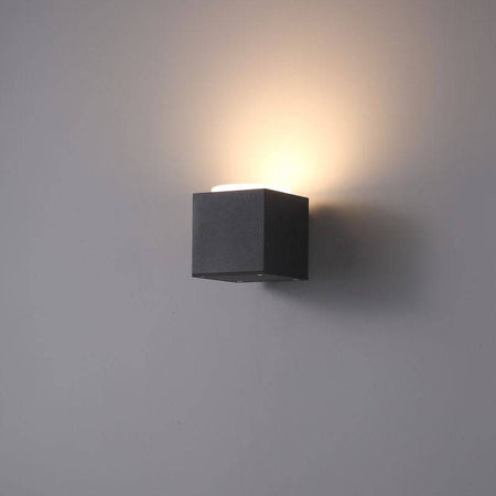 black outdoor uplighter wall light shown on a white wall 