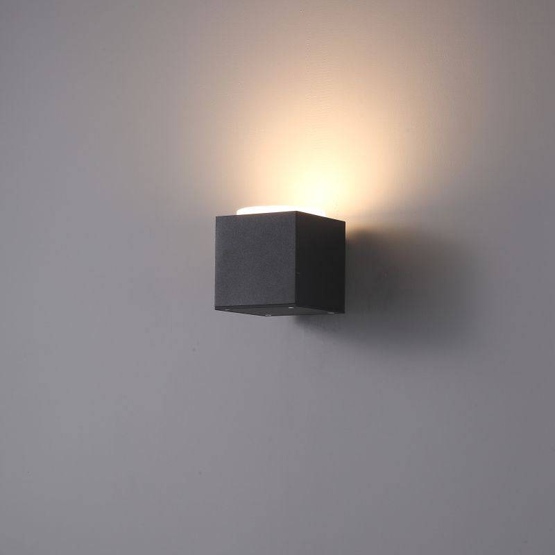 black outdoor uplighter wall light shown on a white wall 