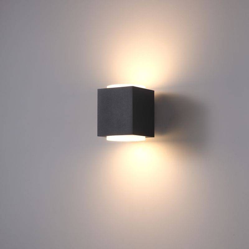 black outdoor up and down light shown mounted on a white wall 