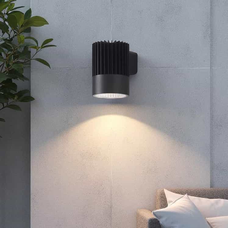 black large outdoor wall downlight mounted on a concrete outside wall 