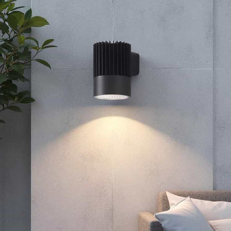 black large outdoor wall downlight mounted on a concrete outside wall 