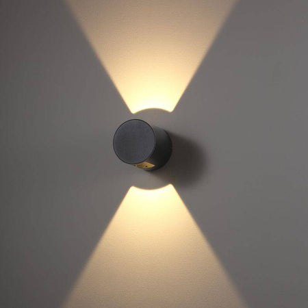 black outdoor up down wall light installed on a white wall