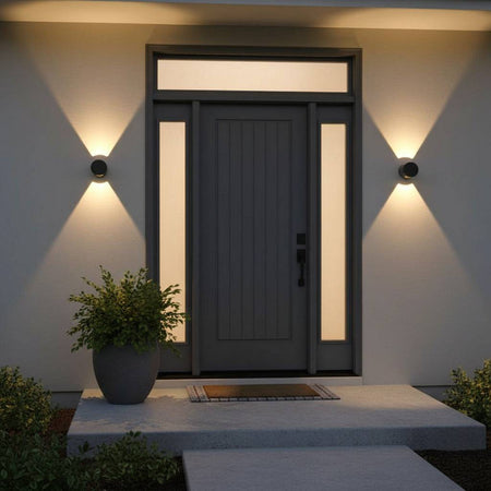 black outdoor up down wall light mounted either side of a modern front door on the wall 
