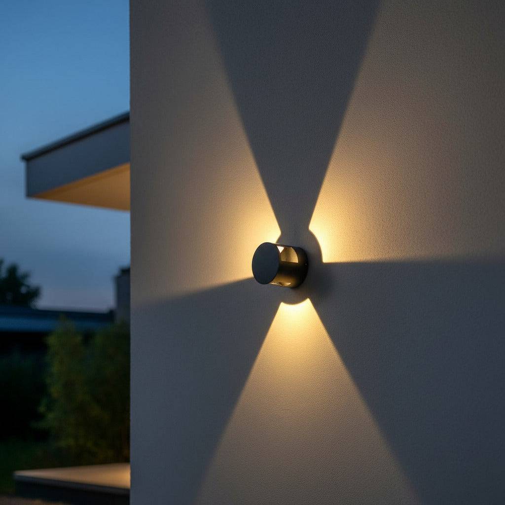 black wall mounted outside light mounted on a white wall outside a modern house 