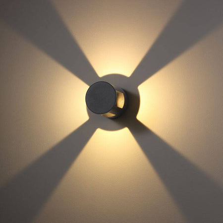 black outside wall light shown mounted on a white wall 