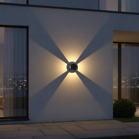 black outside wall light mounted on the exterior wall of a home in between 2 large windows