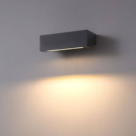 black outdoor down wall light shown mounted on a white wall 