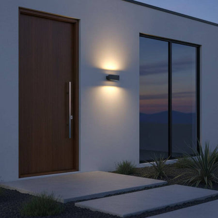 black up and down light mounted next to a wooden front door outside a modern house 