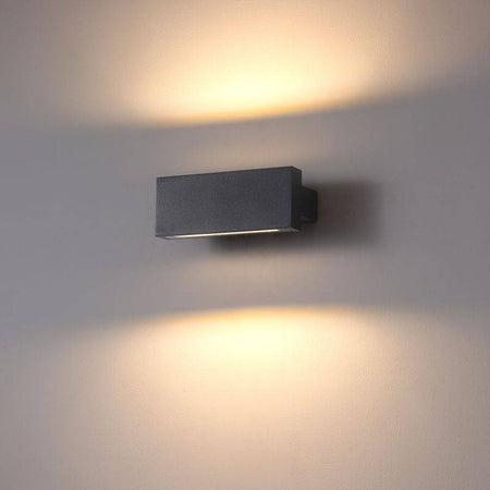 black up and down light mounted on a white wall 