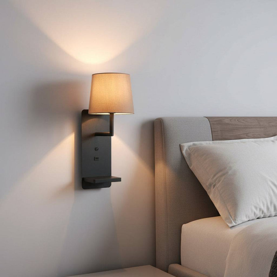 black reading wall light for bedroom installed on a wall in a modern bedroom next to the bed. 