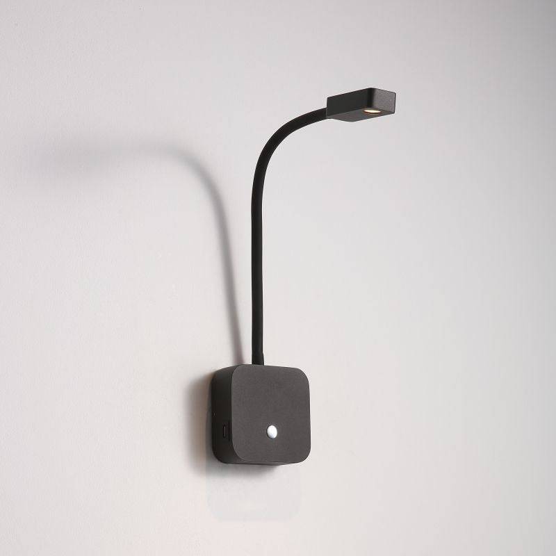 blakc bedroom reading light with USB ports installed on a white wall