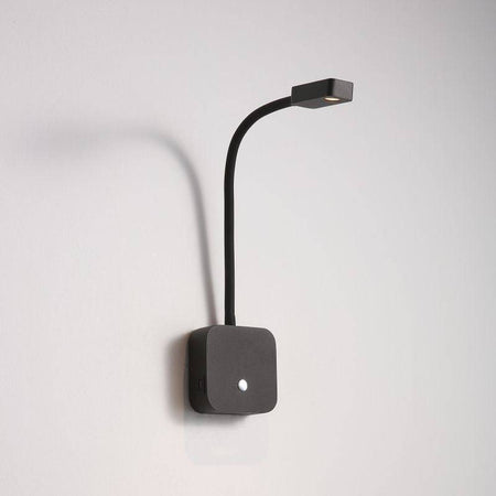blakc bedroom reading light with USB ports installed on a white wall