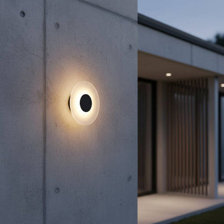 black wall outdoor lamp mounted on the concrete exterior wall of a modern home