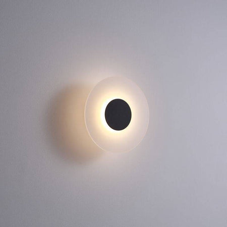 black bath sconce light shown mounted on a white wall 