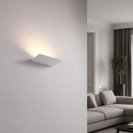 White indoor upplight wall light on  a light background in a lounge of a modern home