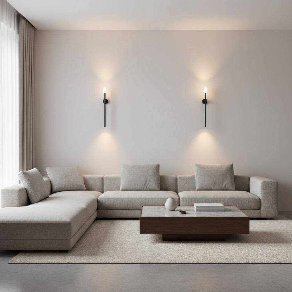 Black up down wall light indoor two lights on a plain wall above a corner sofa and coffee table