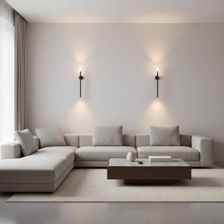 Black up down wall light indoor two lights on a plain wall above a corner sofa and coffee table